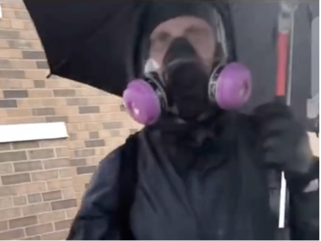 Questions raised over masked white man with umbrella seen calmly smashing windows before Minneapolis riots