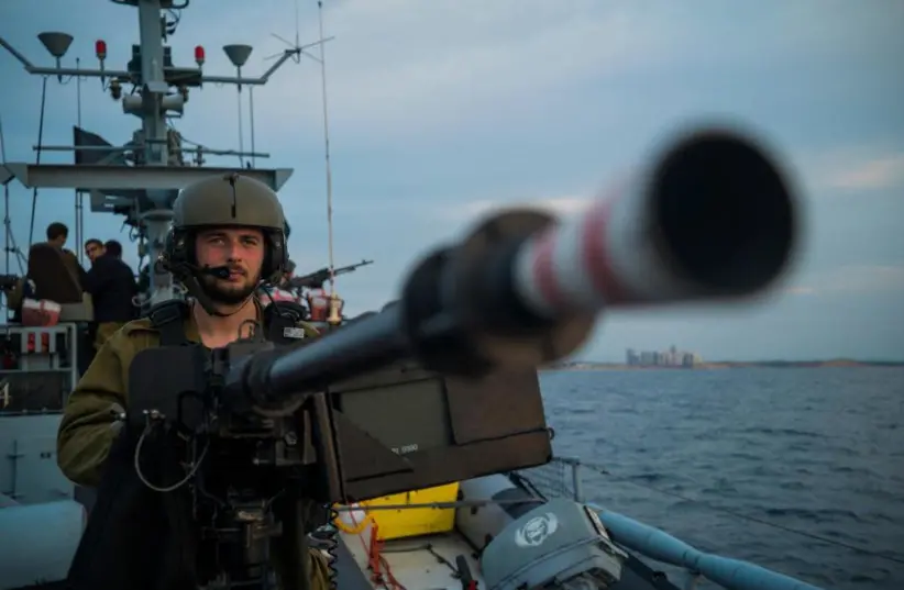 A member of the Navy's 914 Squadron is seen with his gun at the ready.