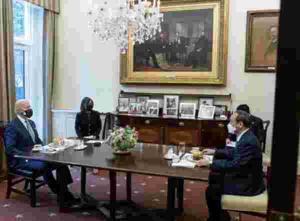Double-masked Biden gives Japan’s Prime Minister a burger and fries