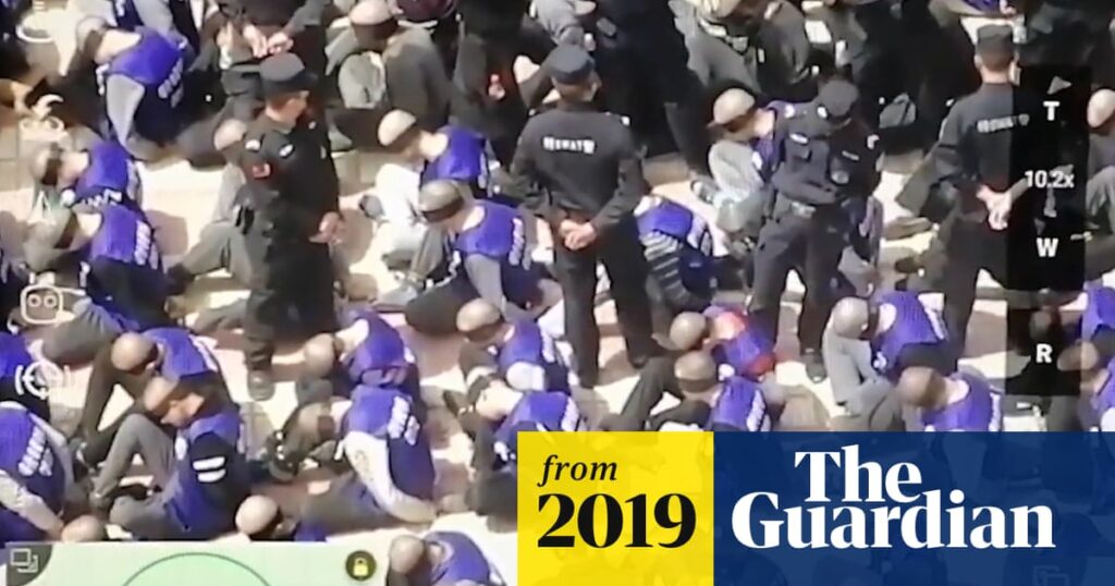 China footage reveals hundreds of blindfolded and shackled prisoners