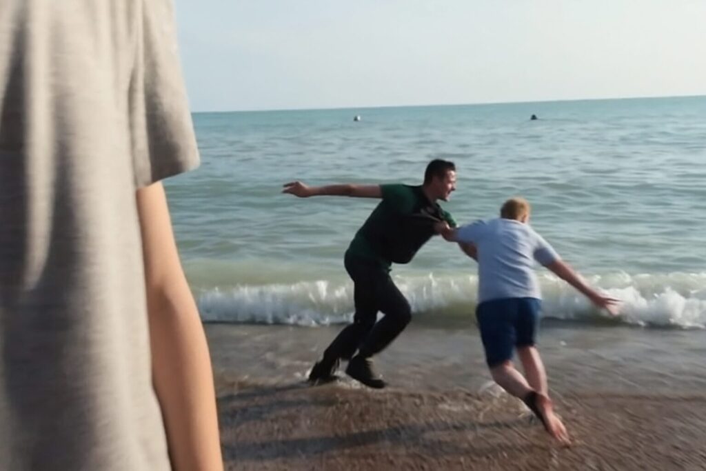 Viral footage of a boatload of migrants tackled and detained by a group of tourists on the beach