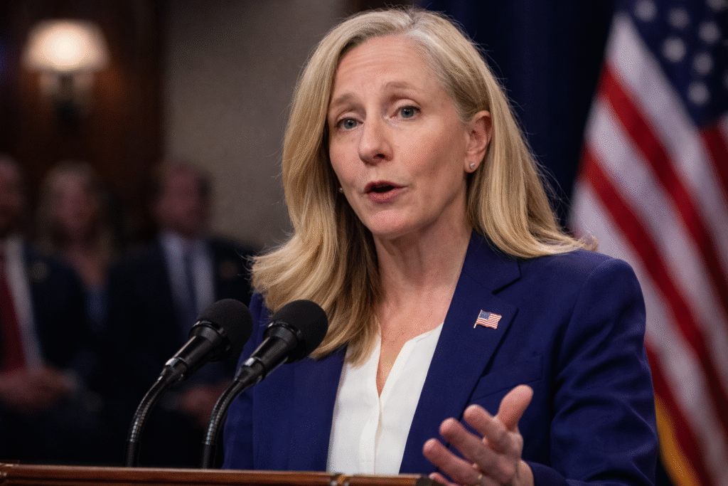 Abigail Spanberger speaks at a podium during a televised State of the Union response, with blurred audience members behind her.