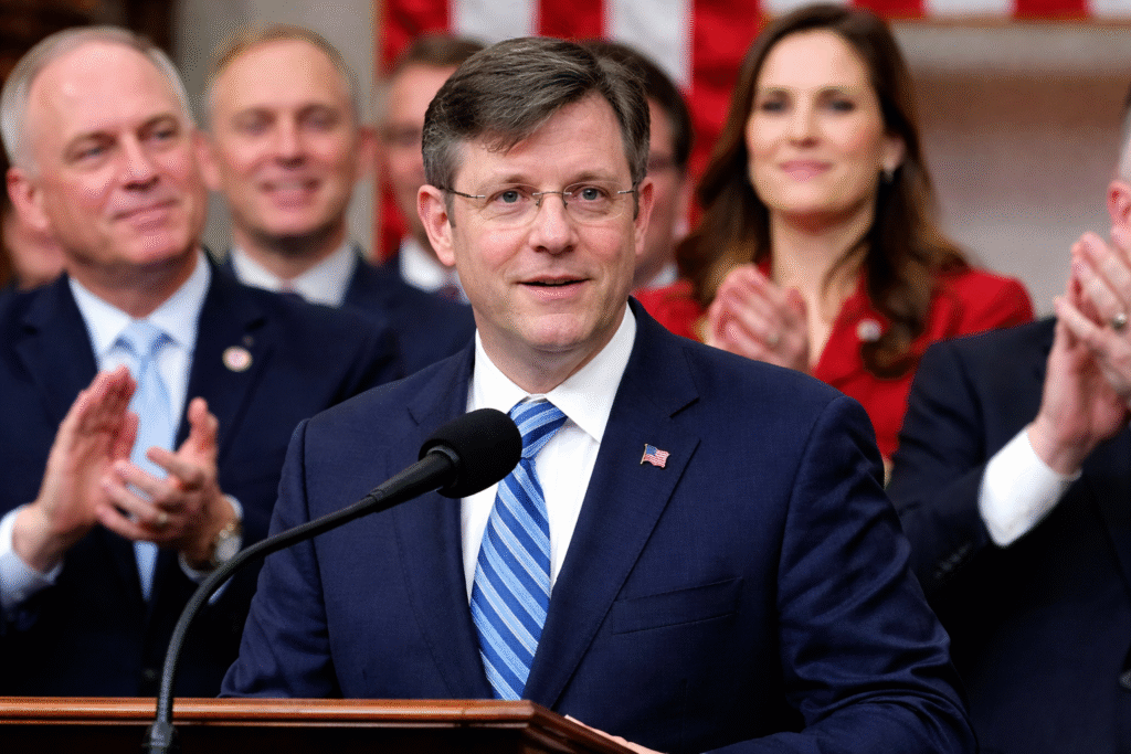 Speaker Mike Johnson addresses the U.S. House chamber as Republican lawmakers stand behind him applauding during debate on a government funding measure.