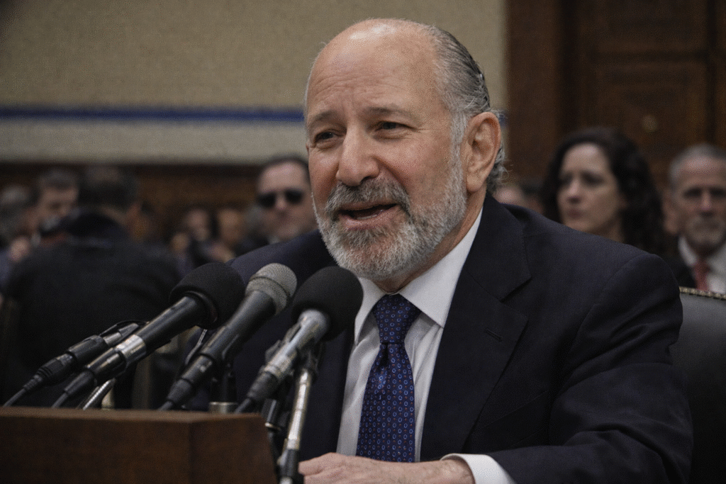 Howard Lutnick, U.S. Commerce Secretary, speaking during a television interview with slicked-back gray hair and a trimmed beard.