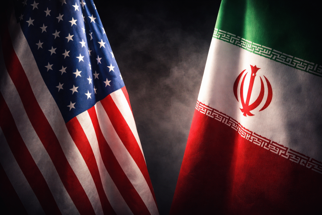United States and Iranian flags positioned opposite each other, symbolizing escalating political and military tensions between the two nations.